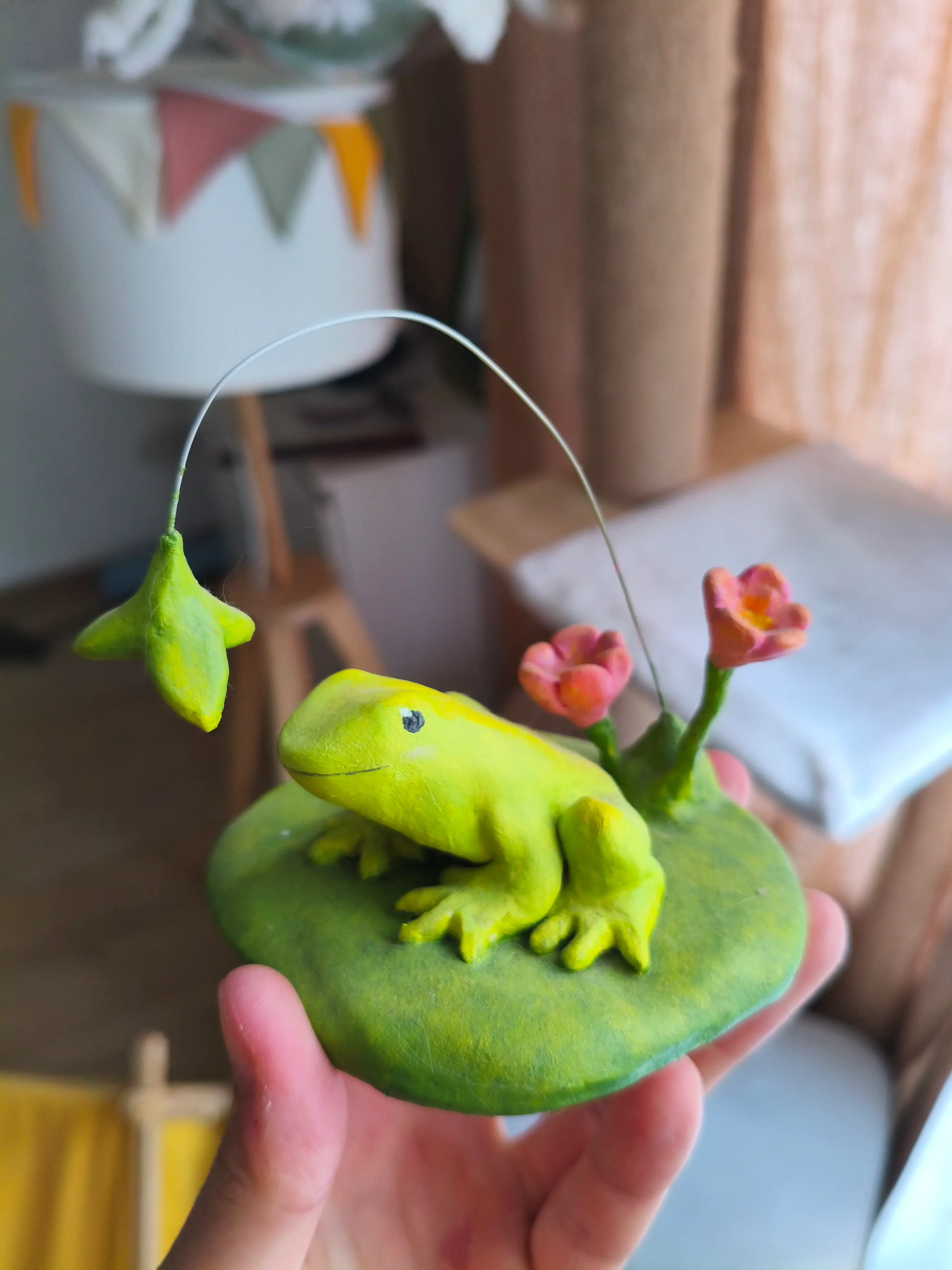 Cute pond frog with flowers