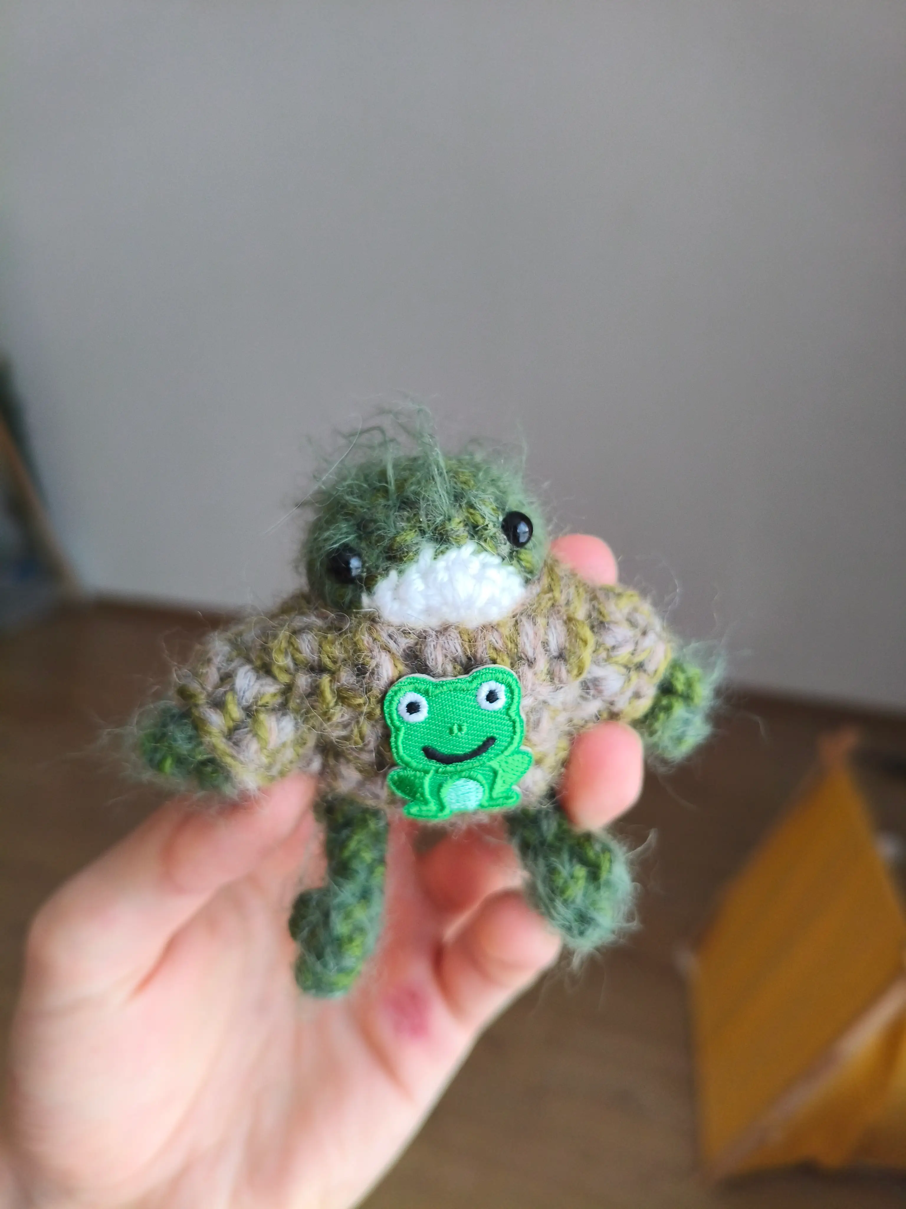 Tiny knit frog with a sweater